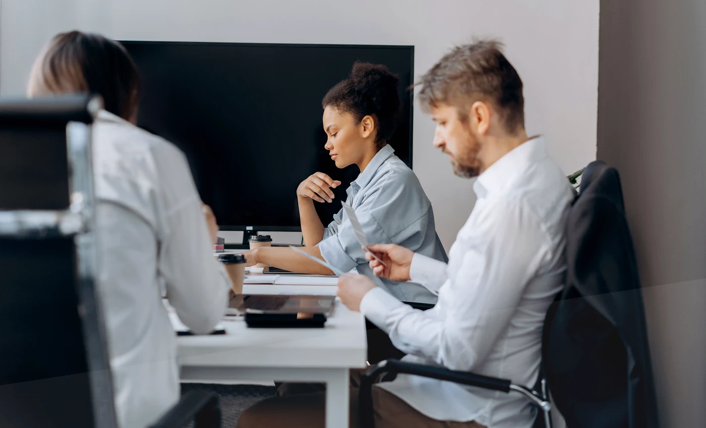 Professionals reviewing annual meeting venue requirements